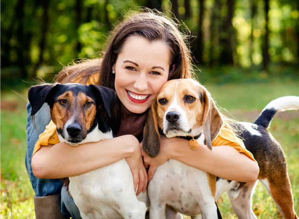 beautiful woman posing with her dogs